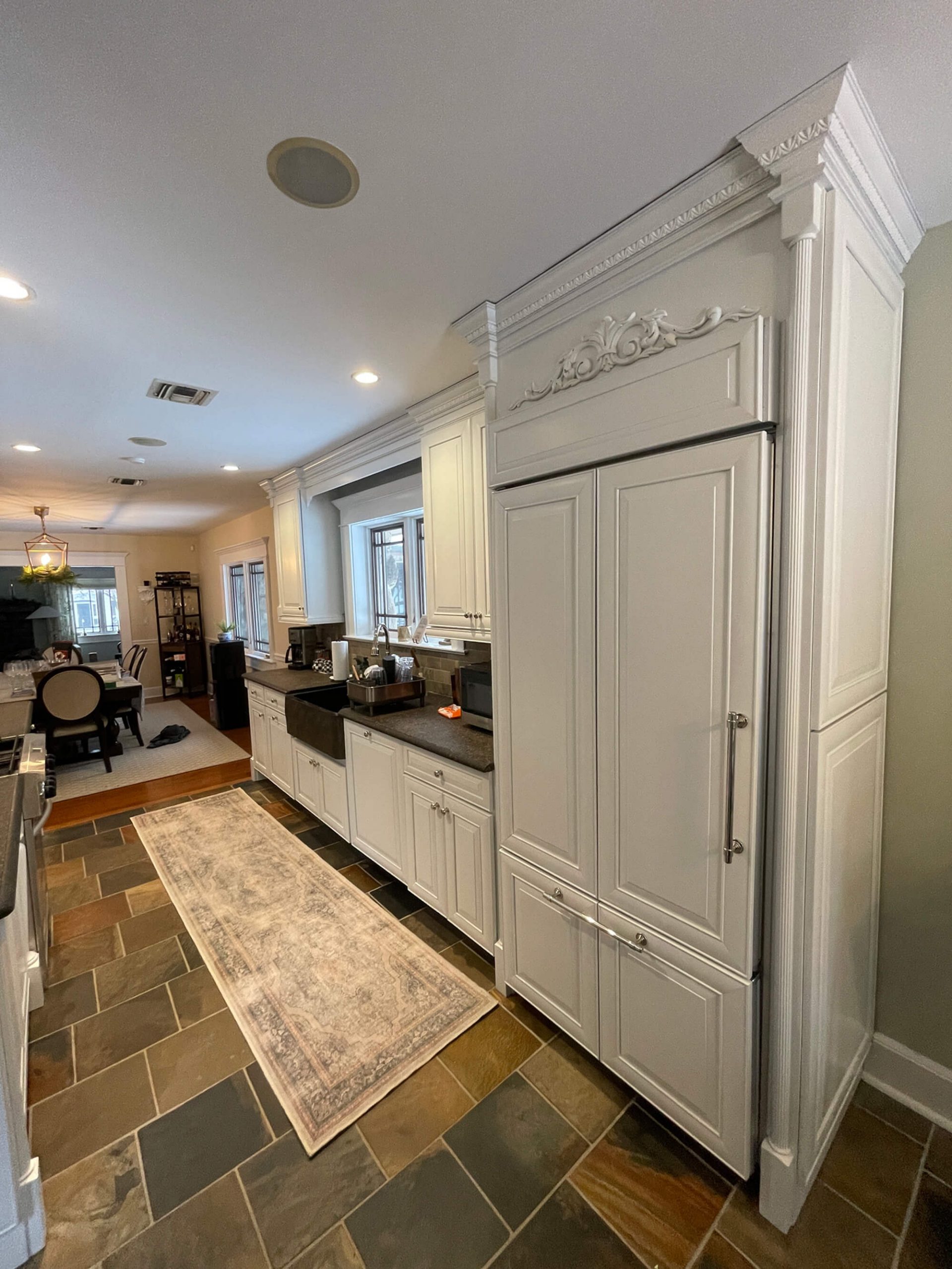 White cabinet painting with decorative crown molding and dark granite countertops in Hudson Valley, NY