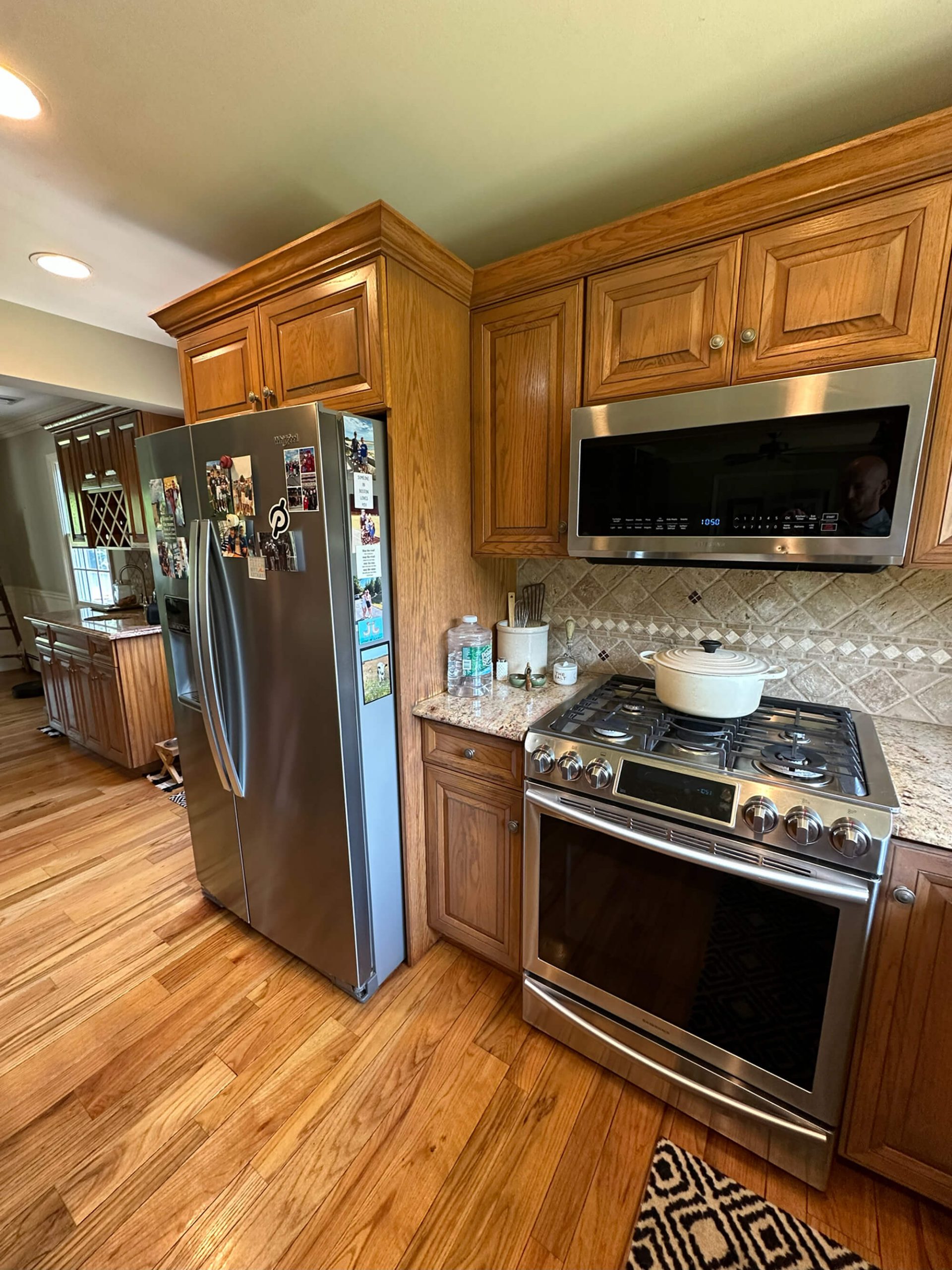 Oak kitchen cabinets with stainless steel appliances in a Warwick, NY home, ready for a modern cabinet painting refresh by Willow Tree Painting & Home Improvement.