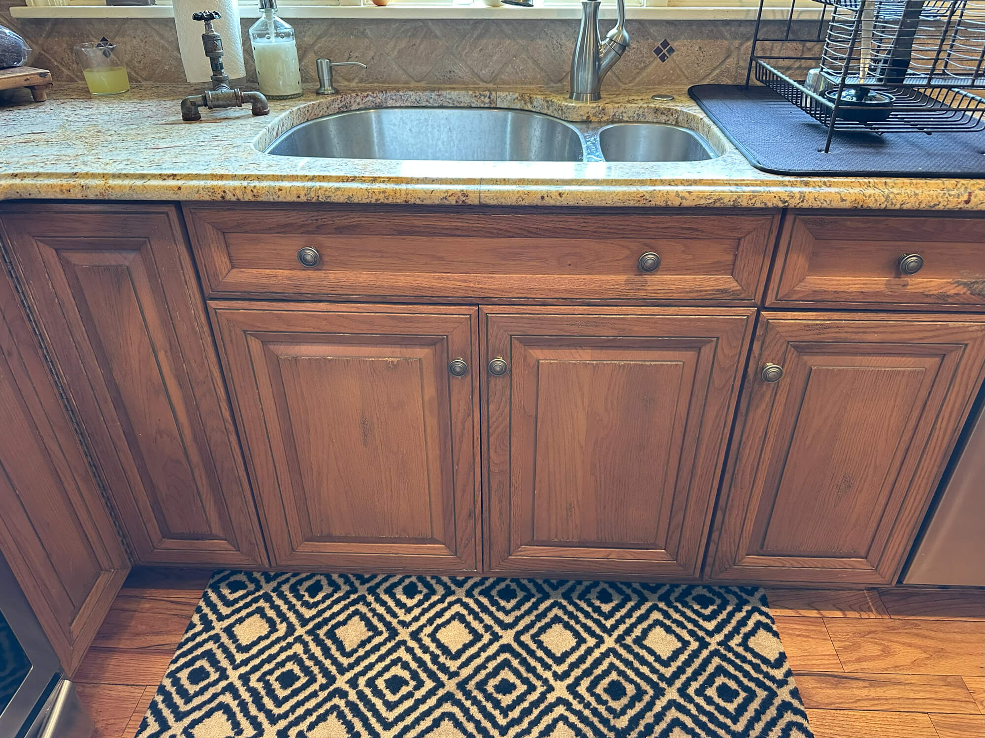Oak kitchen cabinets with granite countertop and stainless steel sink, awaiting a stunning cabinet painting transformation by Willow Tree Painting & Home Improvement in Warwick, NY.4sFast