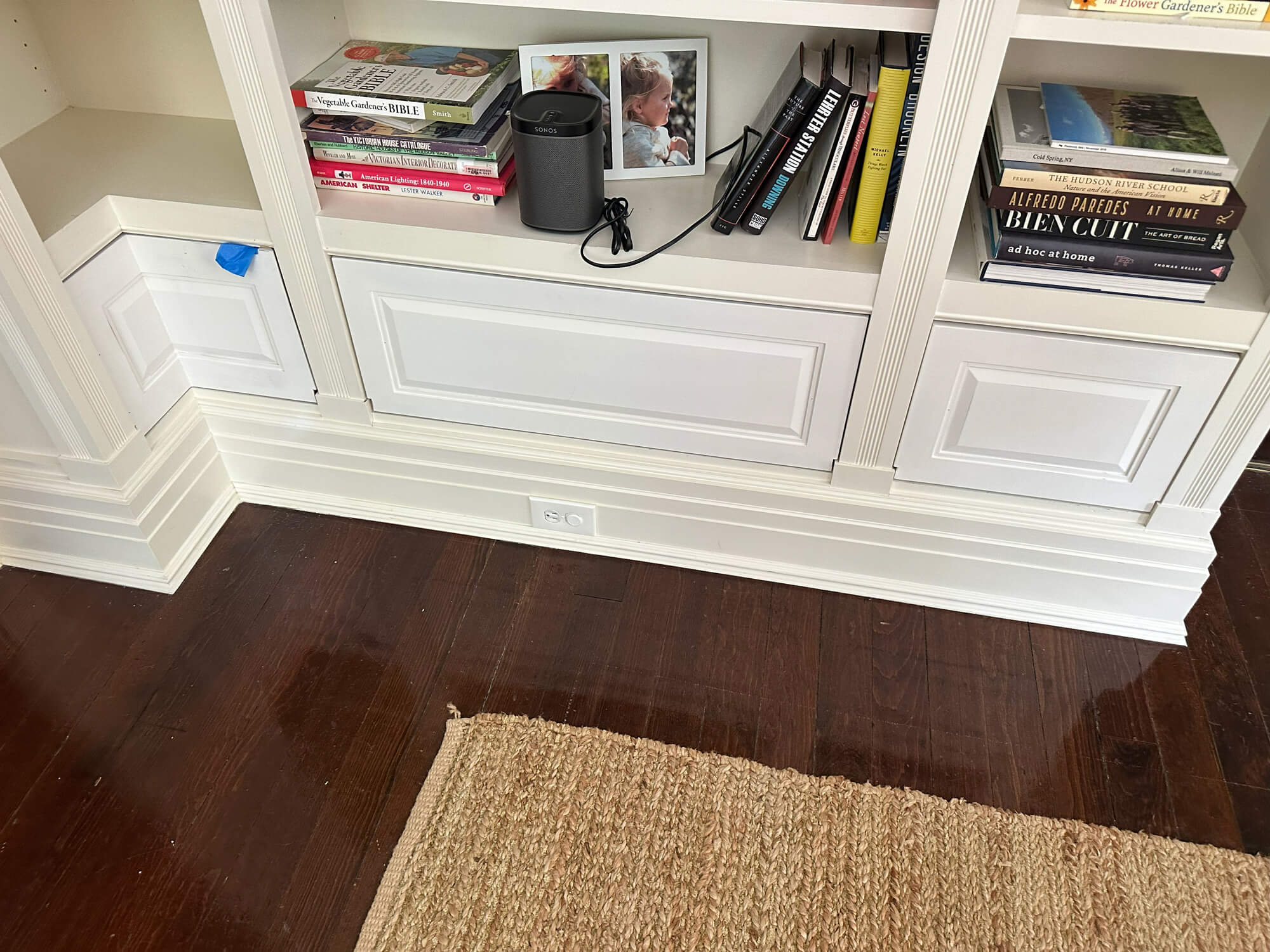 After photo of freshly refinished white built-in cabinetry with crisp trim and classic raised-panel doors, expertly transformed by Willow Tree Painting & Home Improvement in Warwick, NY.