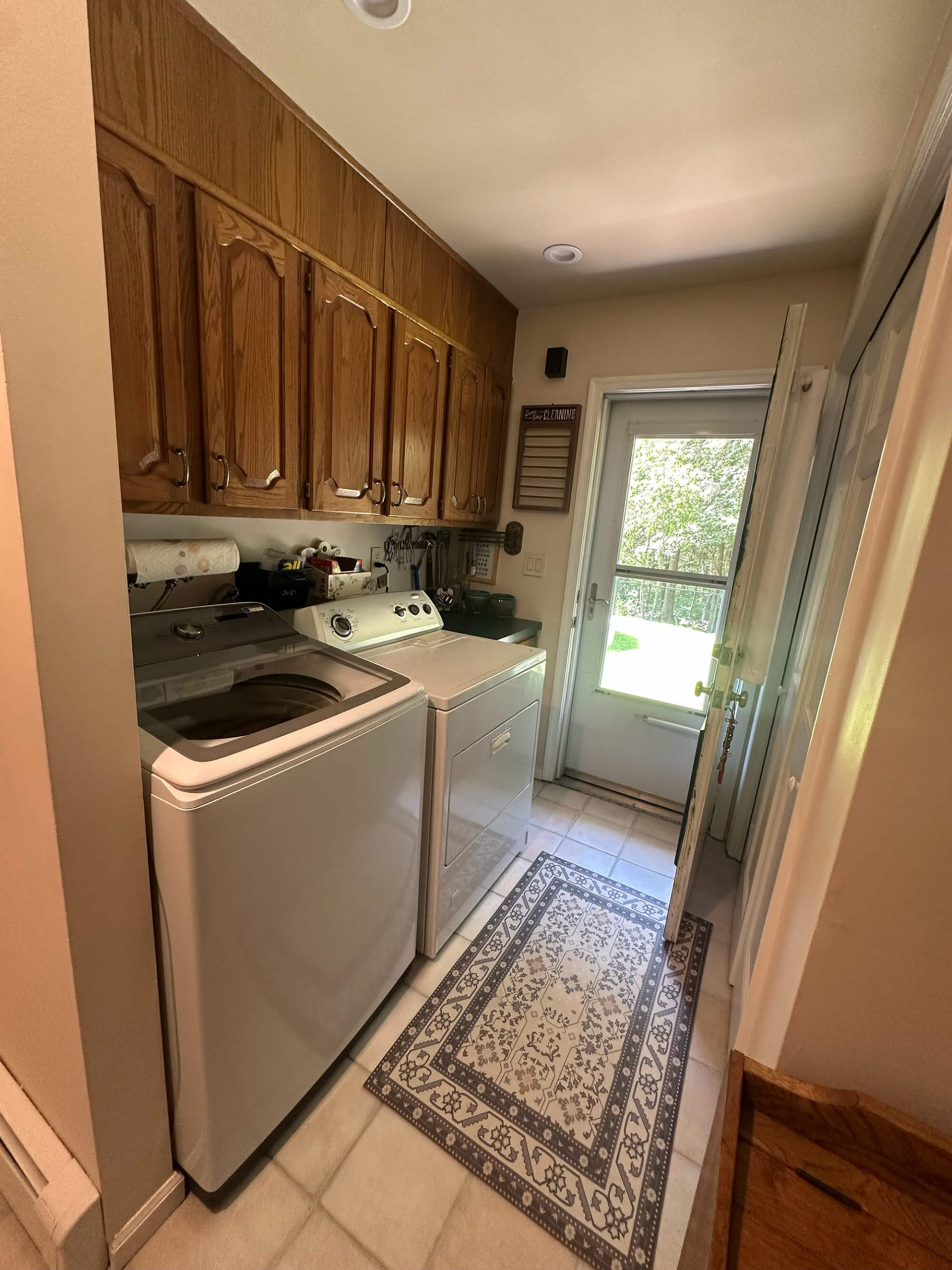 Laundry room with stained oak cabinets and custom painted countertops by Willow Tree Painting & Home Improvement