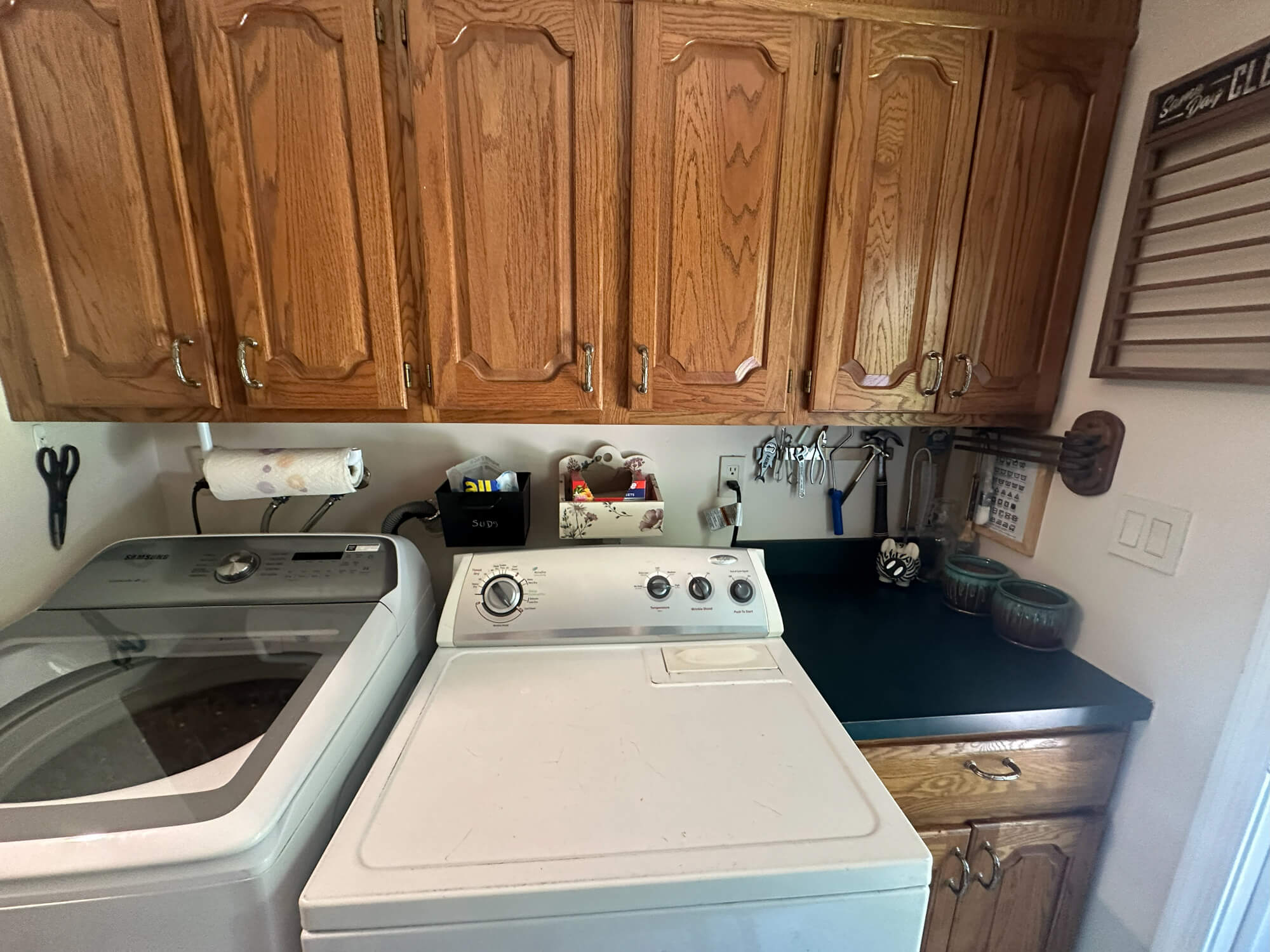 Refinished oak cabinets with custom painted countertops in laundry room by Willow Tree Painting & Home Improvement