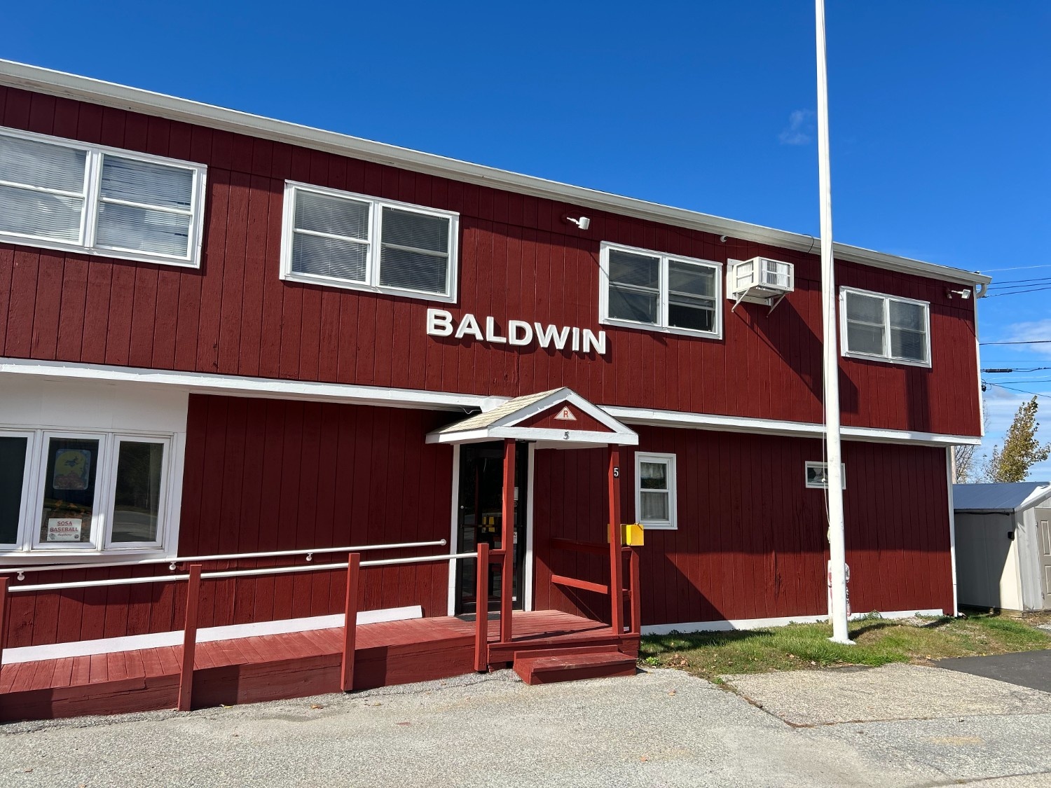 Finished commercial building exterior featuring vibrant red siding and crisp white trim, showcasing the quality results of Commercial Exterior Painting in Warwick, NY.