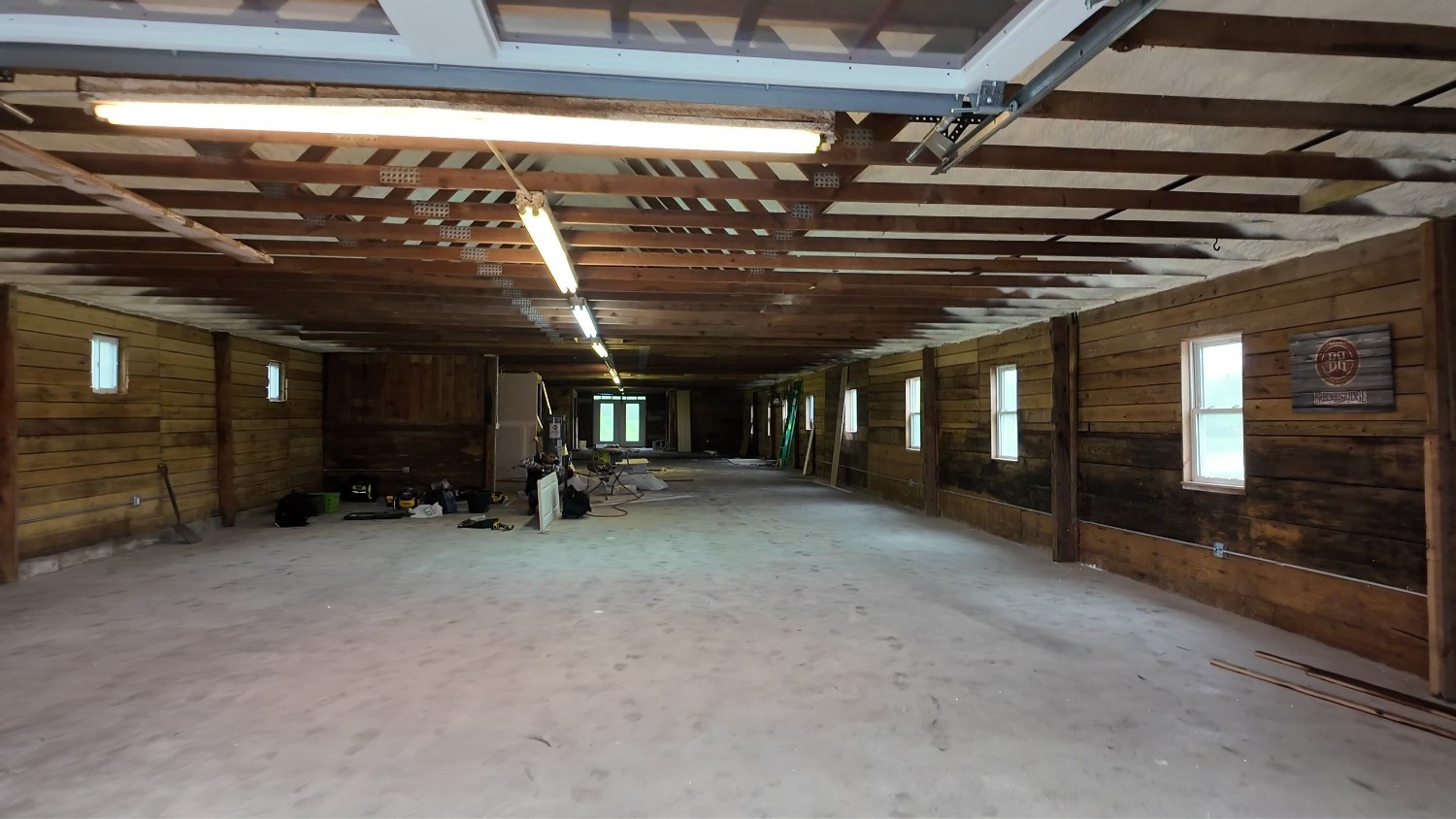 Commercial Interior Painting in Warwick, NY on a large long structure with exposed wood walls and ceiling beams.