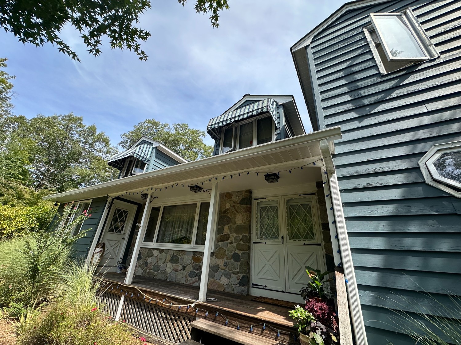Professional Exterior Painters in Warwick, NY delivering high-quality siding and trim painting on a complex residential home with stone accents.