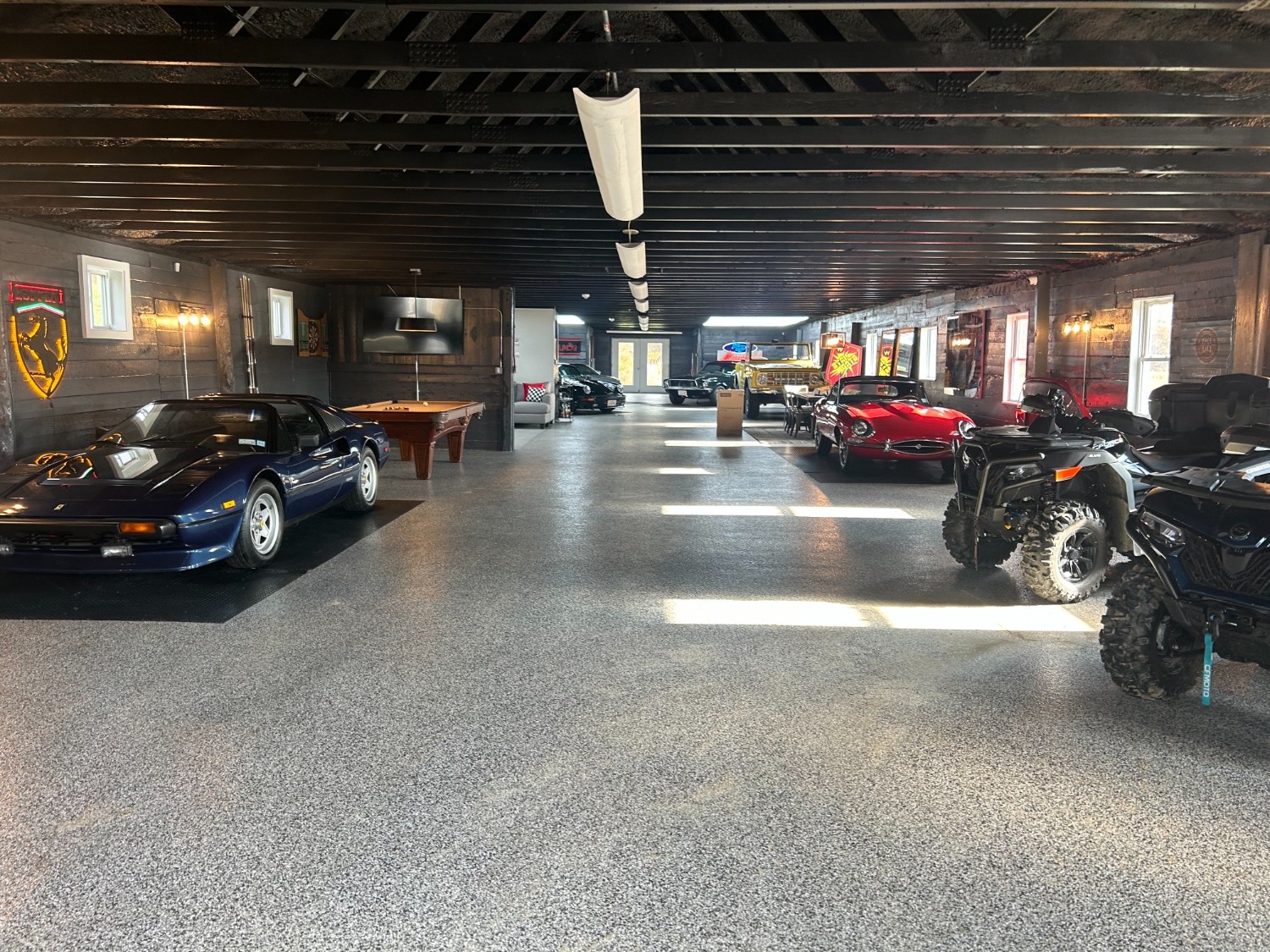 Luxury Garage Epoxy Floor and Interior Painting New York New Jersey on a vehicle collection space with dark stained wood walls and ceiling.