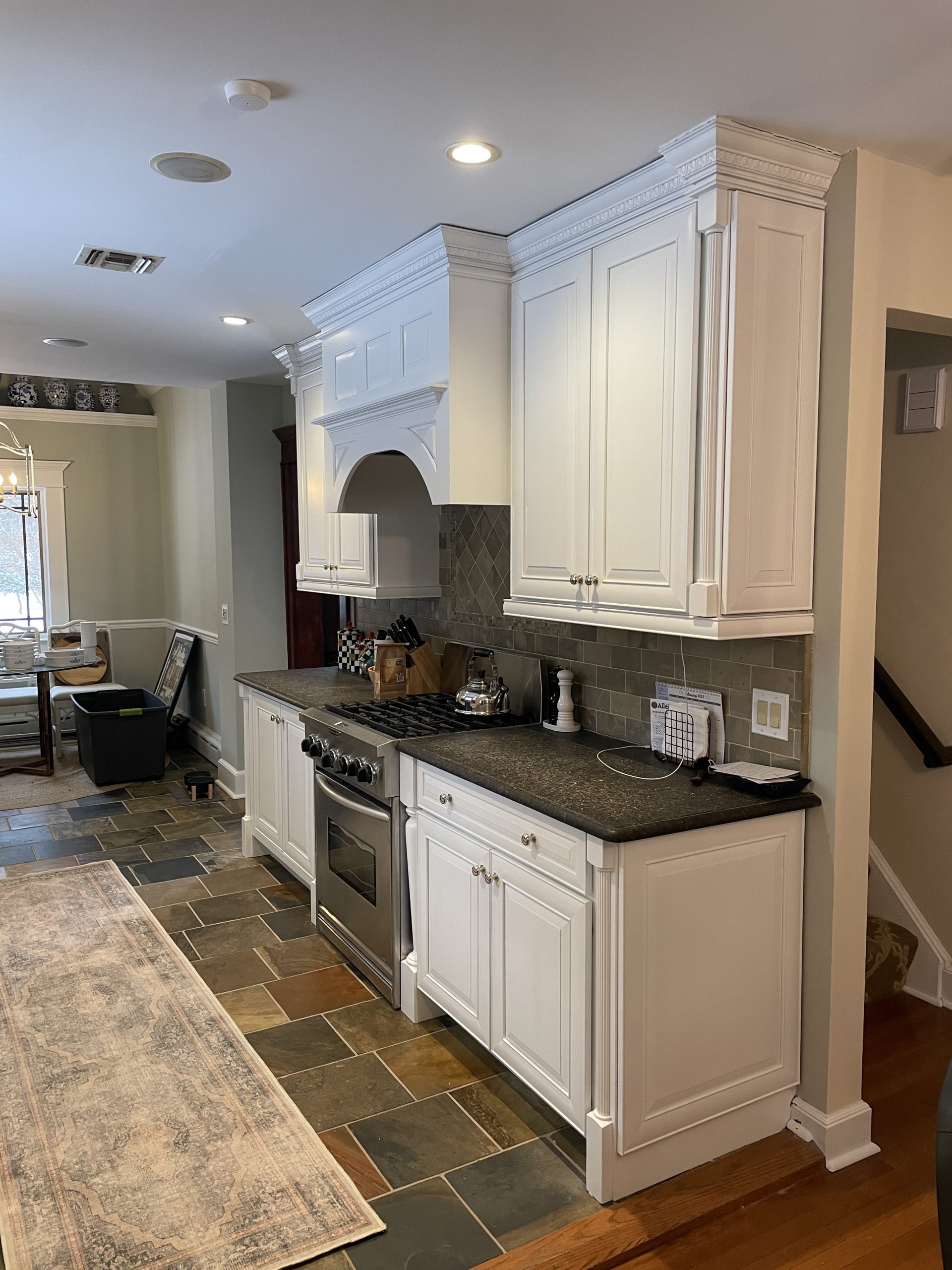 Luxury Custom Cabinet Refinishing New York New Jersey featuring white cabinets, decorative crown molding, and a custom range hood.