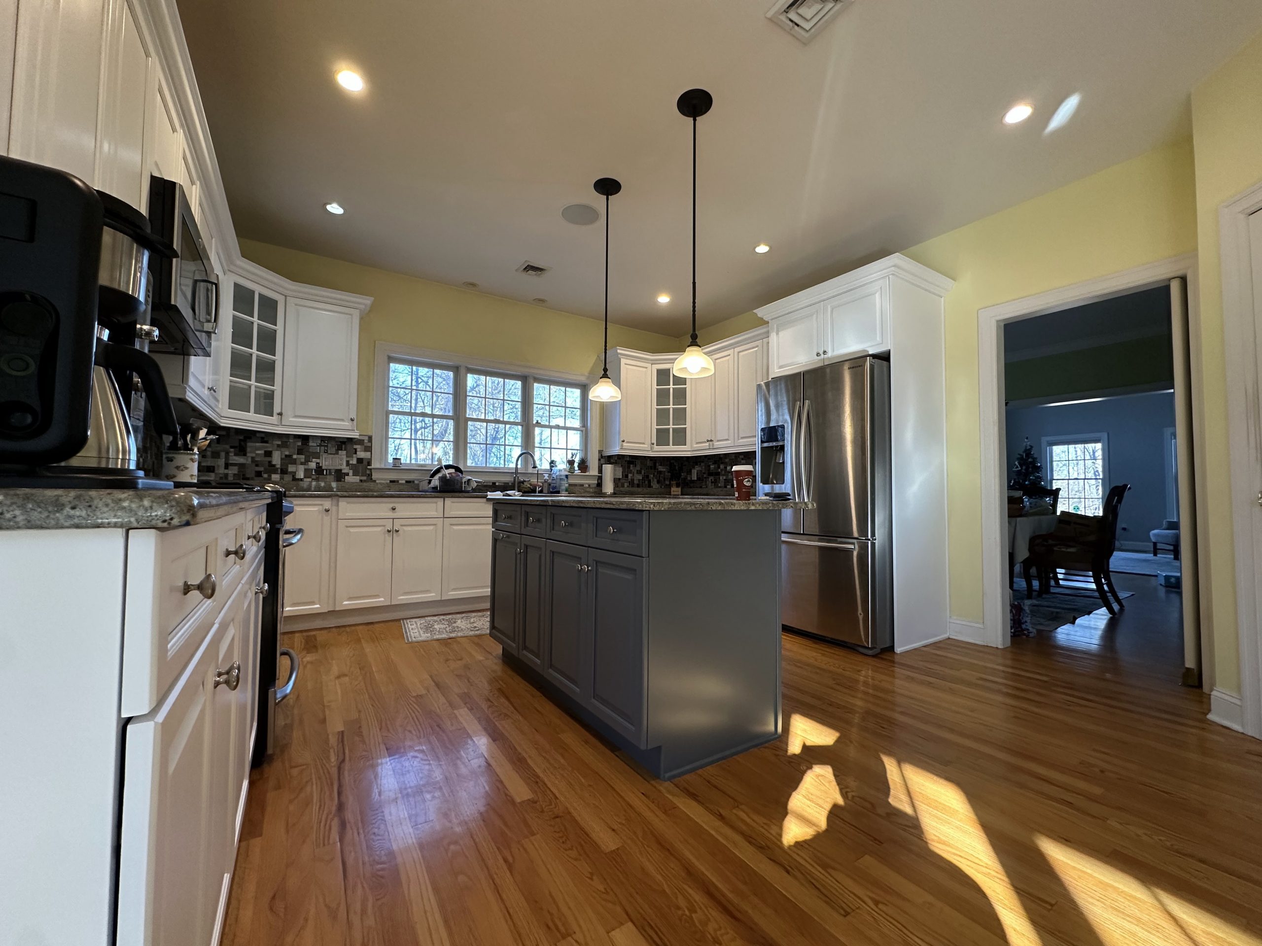 Luxury Two Tone Cabinet Painting Service New York New Jersey featuring white perimeter cabinets and a stylish dark gray kitchen island.