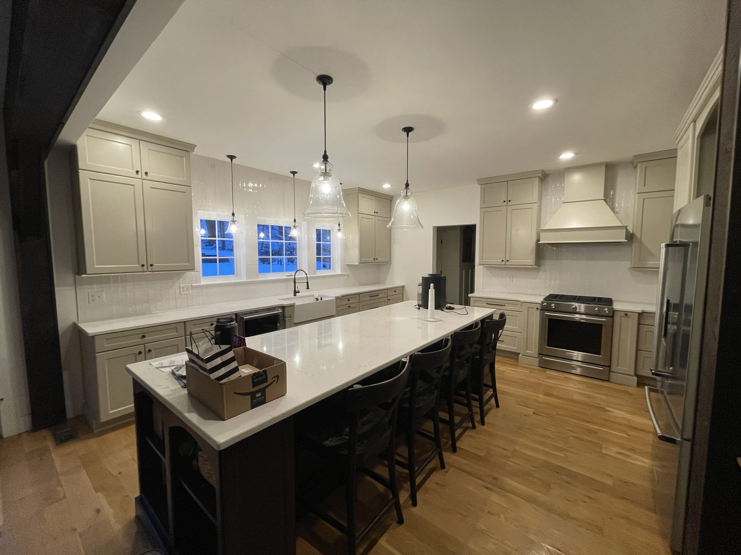 Modern Greige Cabinet Painting Service New York New Jersey featuring light taupe cabinets and a large white quartz island.