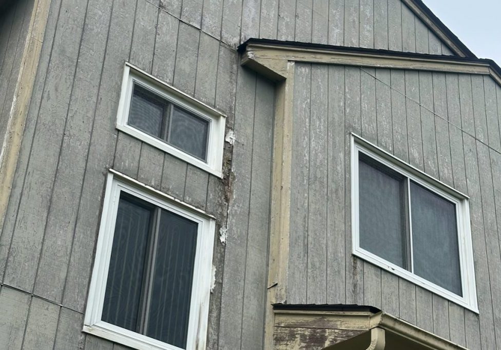 Close-up of exterior wood siding with severe peeling paint requiring restoration and preparation by Willow Tree Painting & Home Improvement in Warwick, NY.