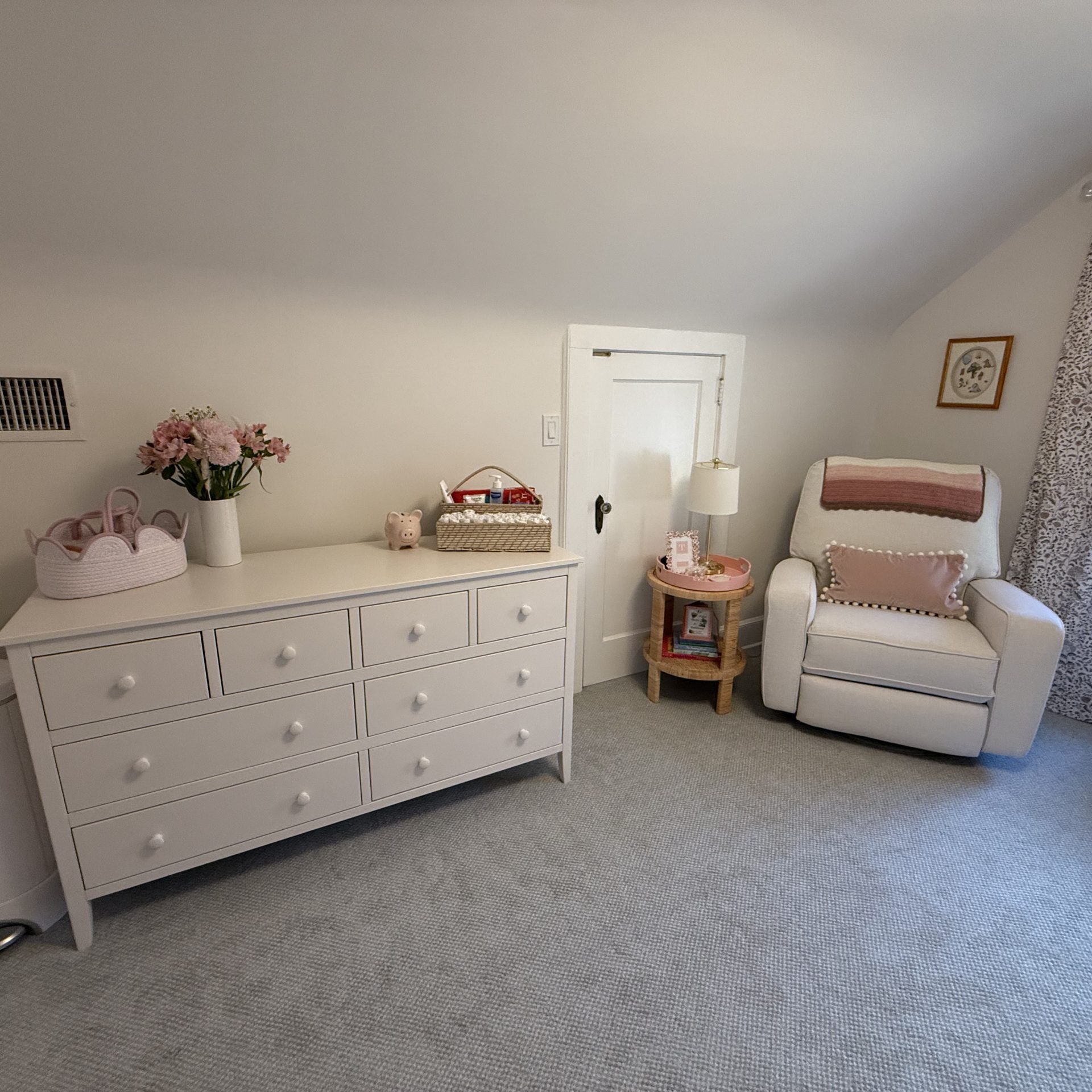 Home Improvement interior painting of a beautiful, bright nursery with crisp white walls, white furniture, and a cozy glider chair.