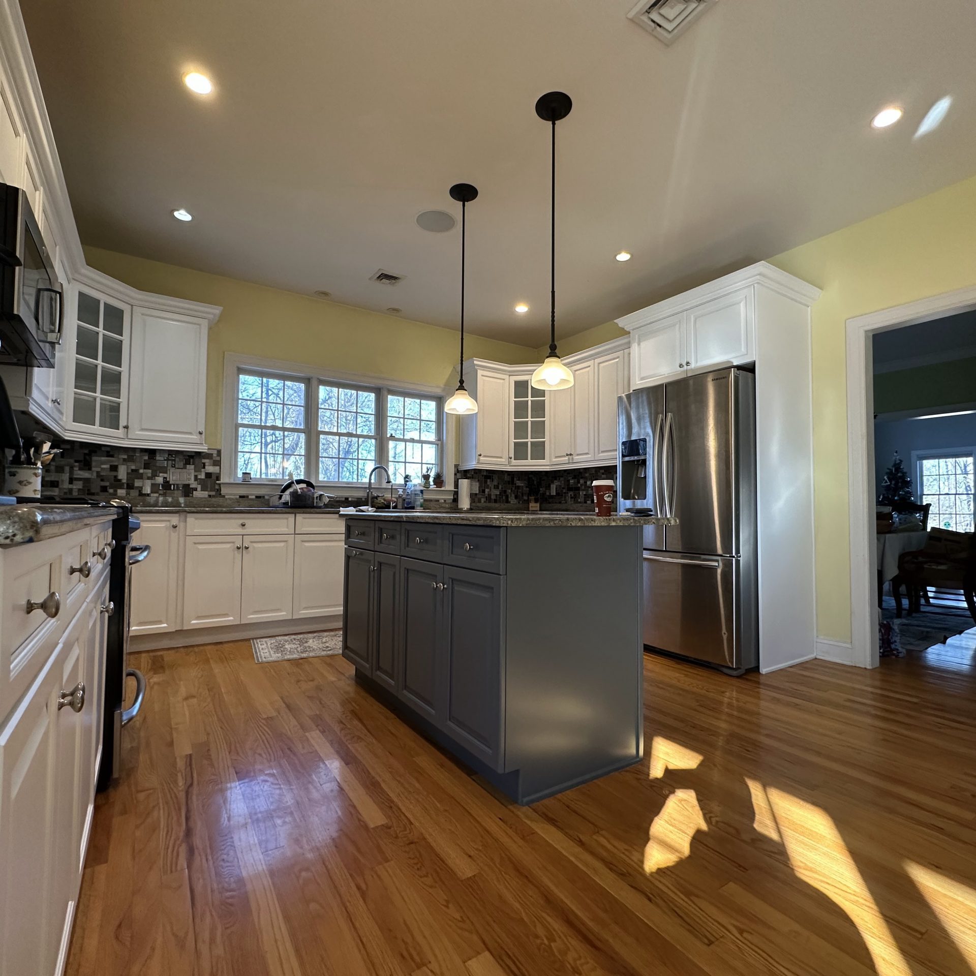 Luxury Two Tone Cabinet Painting Service New York New Jersey featuring white perimeter cabinets and a stylish dark gray kitchen island.