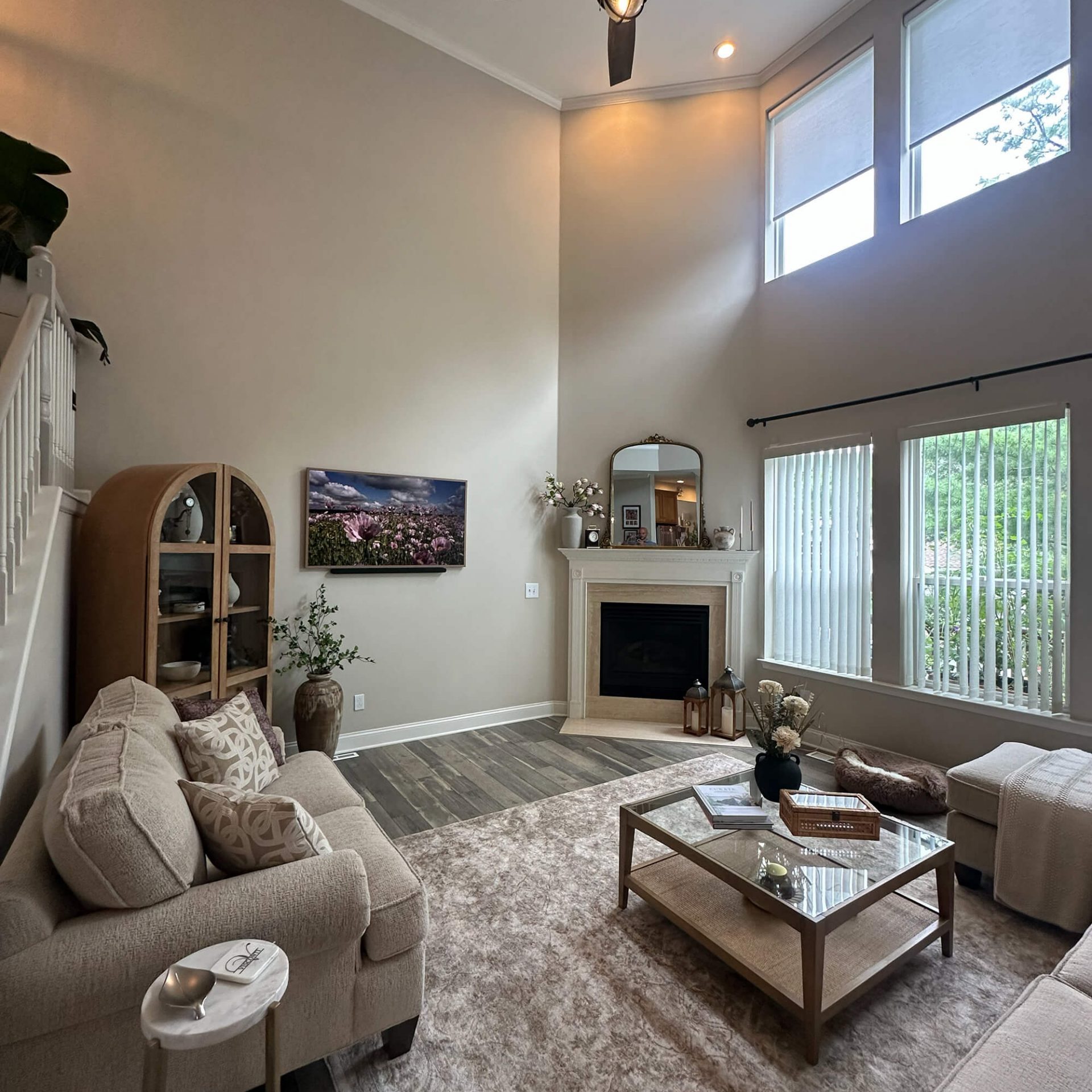 Willow Tree Painting & Home Improvement interior painting of a luxurious two-story living room with a neutral color palette and high ceilings.